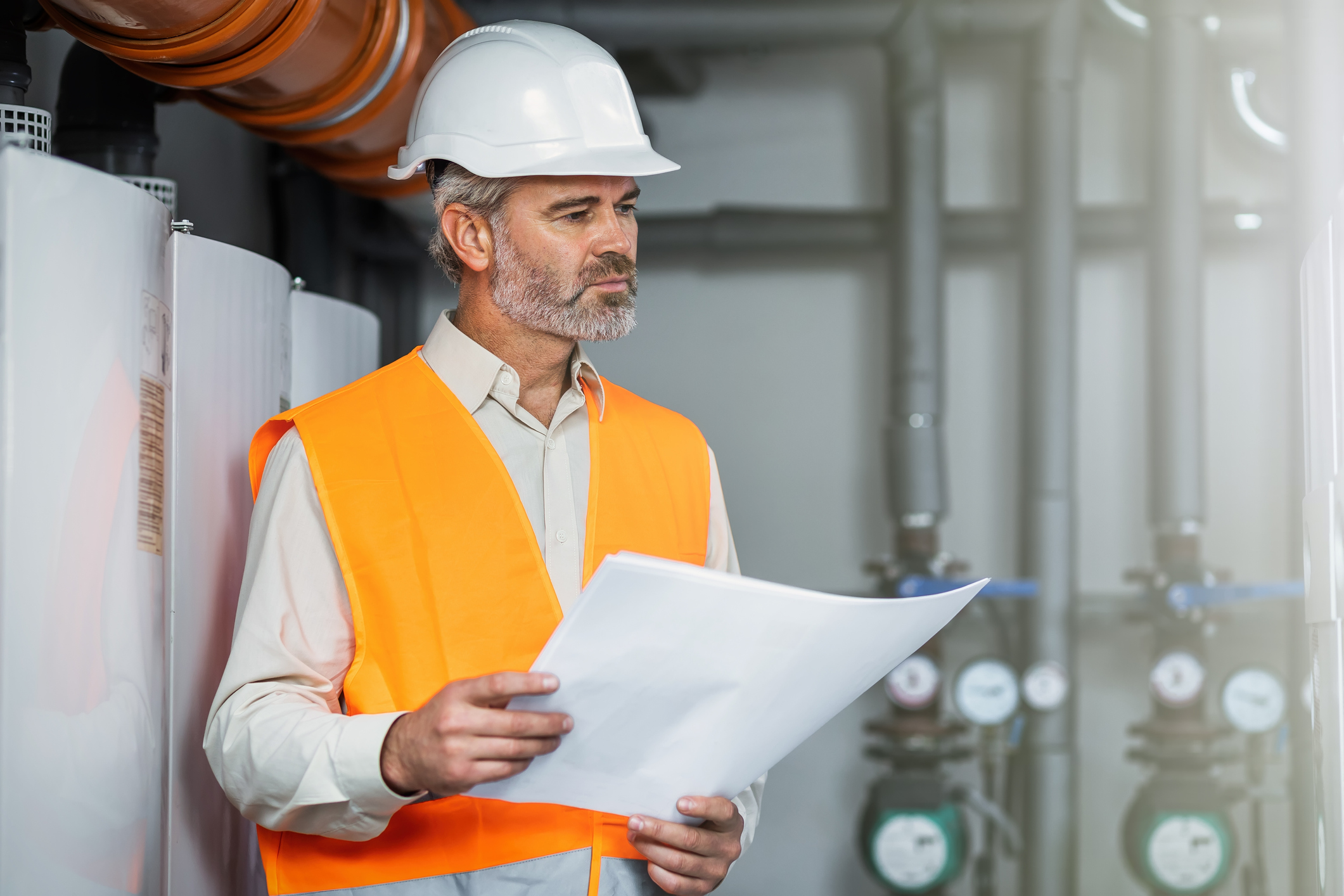 Refinery plant operator maintaining low pressure steam inside power plant. Experienced engineer serviceman trying to detect the problem inside power plant.